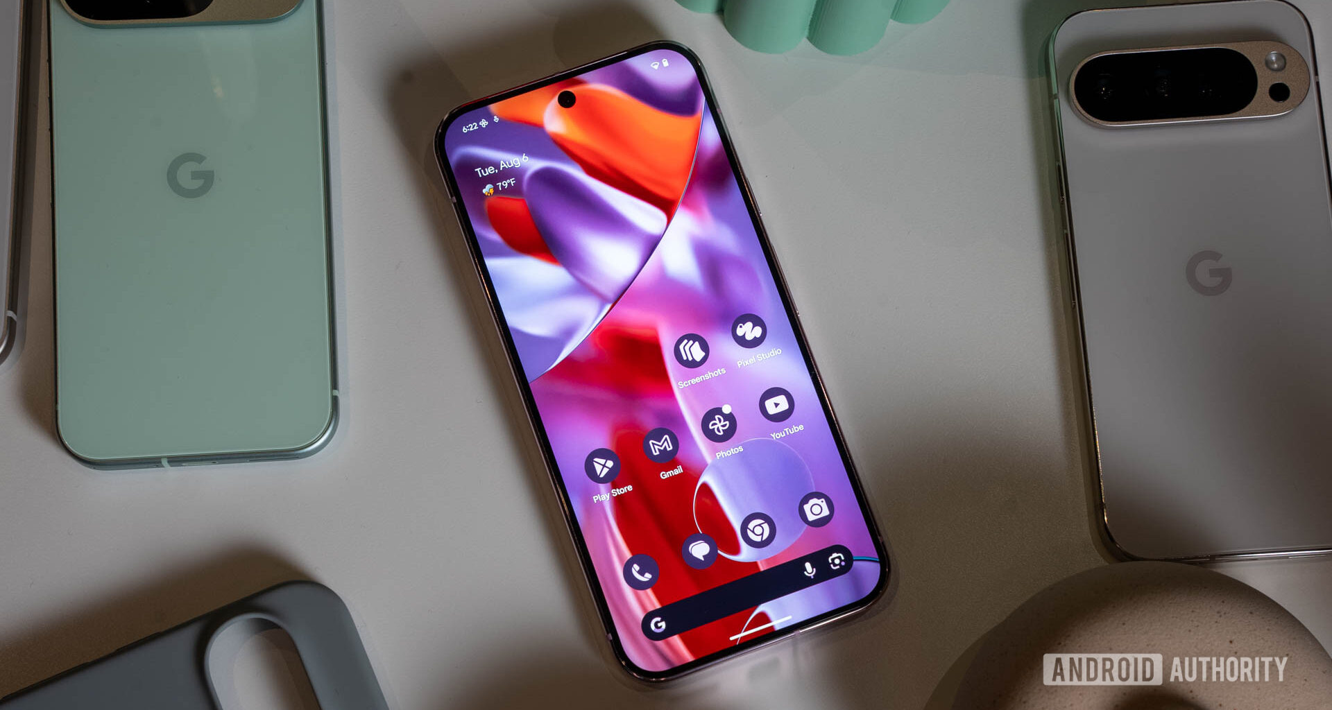 Google Pixel 9 Pro home screen display next to other Pixel phones