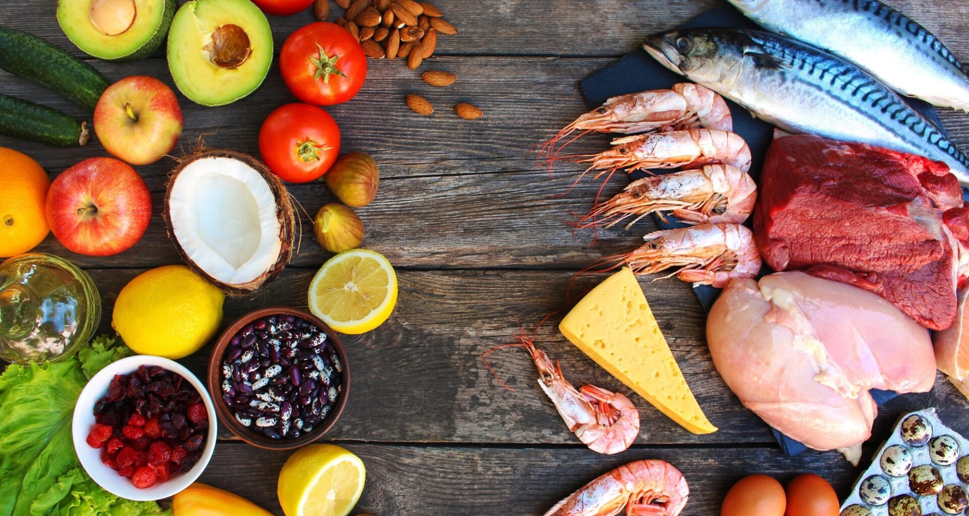 Healthy food of animal and vegetable origin on old wooden background.