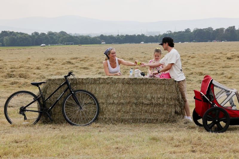 Angel Kelly and David Duffy with Kydi Kelly (6) from Dublin take a snack break in Dublin's Phoenix Park. Photograph: Alan Betson