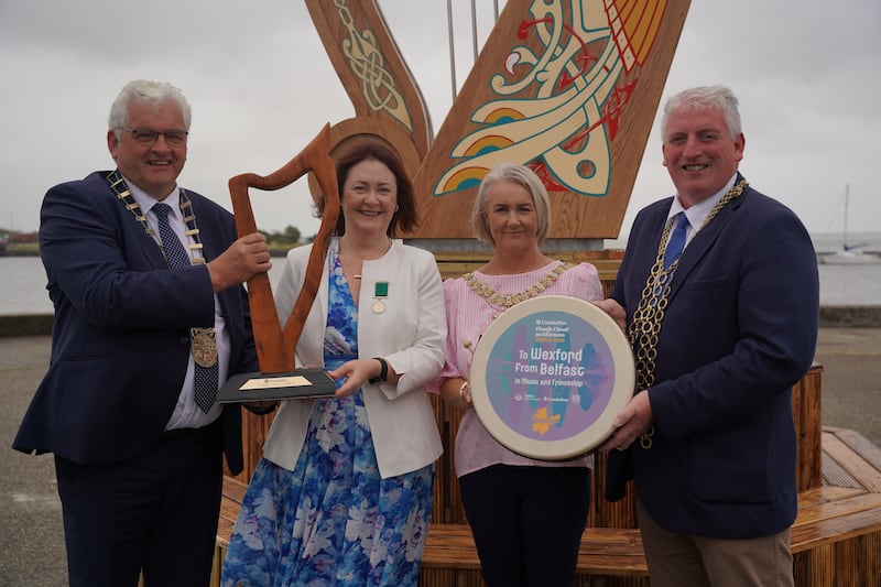 Lord mayor of Belfast Tracy Kelly (second right) was presented with a ‘Fleadh harp’ by mayor of Wexford Garry Laffan. Photograph: Belfast City Council