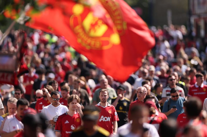 Fans make their way to the stadium prior to Manchester United v Arsenal at Old Trafford. Photograph: Stu Forster/Getty Images