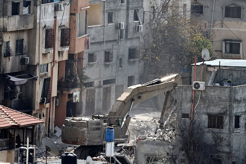 An Israeli military excavator demolishes a building in the Nur Shams camp last March. Photograph:  Zain Jaafar/AFP 