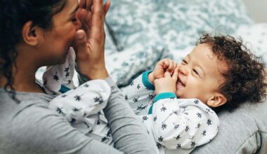 Mother holding baby on her lap and playing. Happy little boy looking at mother.; Shutterstock ID 1368345290; purchase_order: -; job: -; client: -; other: -