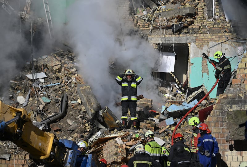 Ukrainian rescuers search a building heavily damaged during a large-scale Russian drone and missile attack on Kyiv. Photograph: GENYA SAVILOV/AFP via Getty Images         