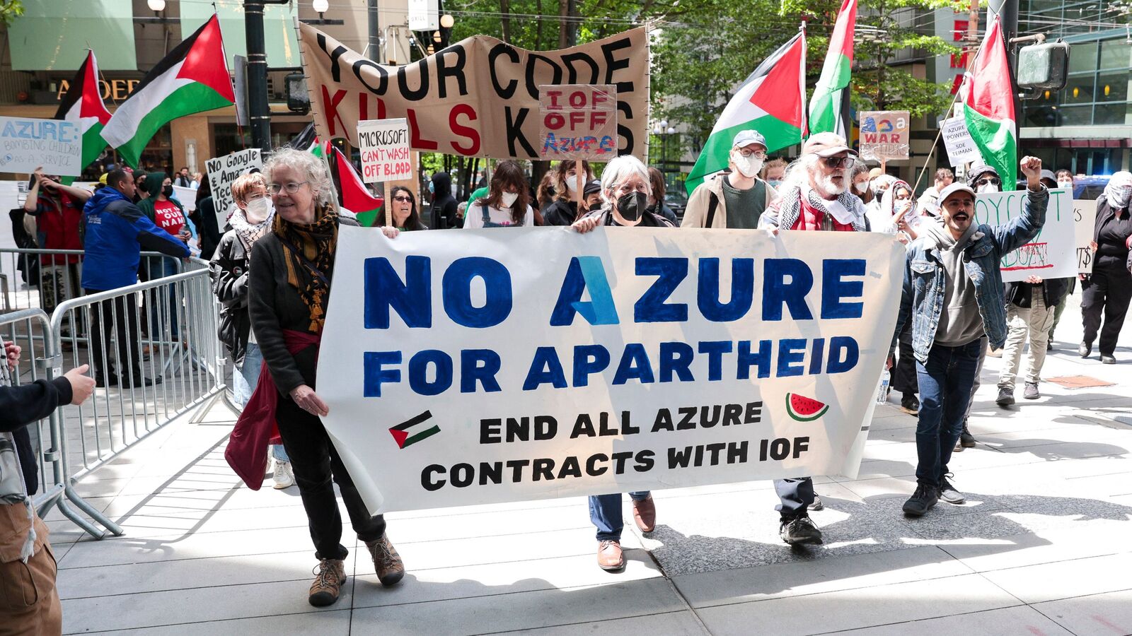 Pro-Palestinian demonstrators hold banners and signs as they protest outside the Microsoft Build conference.