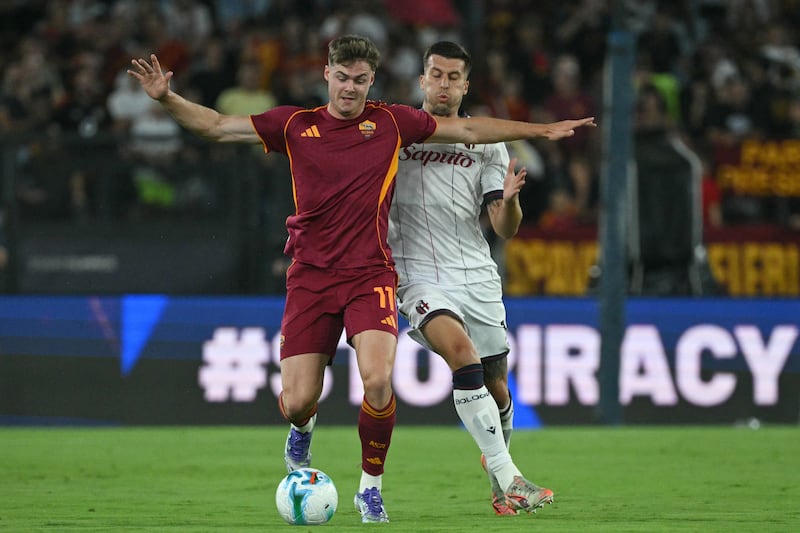 Evan Ferguson fights for the ball with Bologna defender Nicolo Casale. Photograph: Tiziana Fabi/AFP via Getty Images