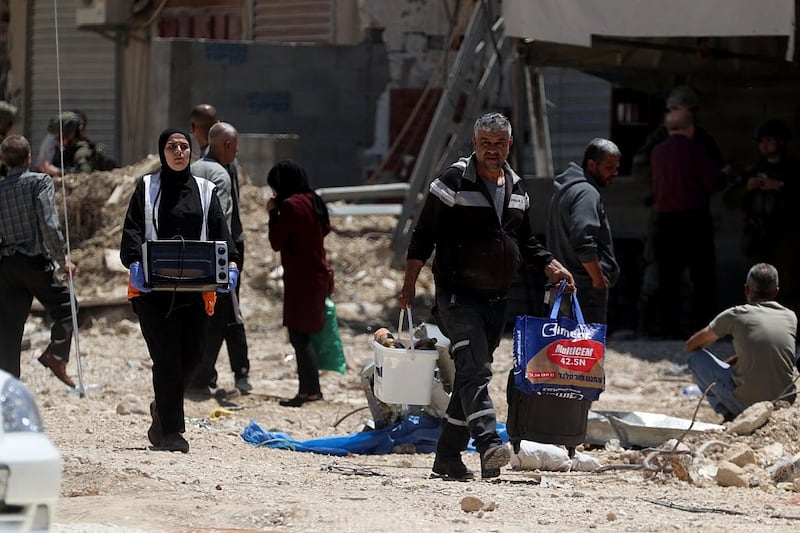 Palestinians take their belongings from their homes following the Israeli army's demolition of several Palestinian homes in Nur Shams refugee camp in May. Photograph: Issam Rimawi/ Anadolu via Getty Images