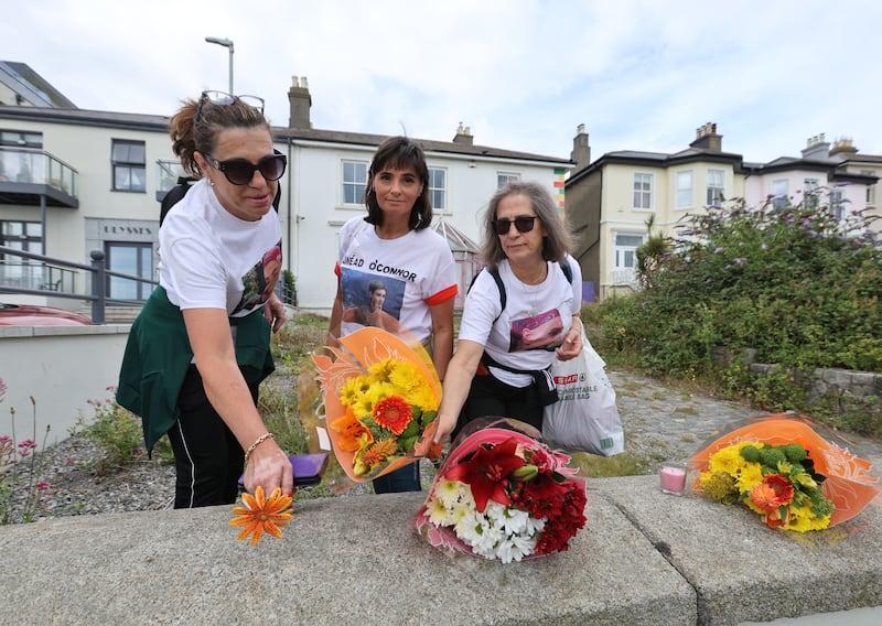 Ana Bento, Maria Correia  and Lina Gouveia from Portugal place flowers at Sinead O'Connor's former home in Bray on the first anniversary of her death. Photograph: Colin Keegan, Collins Dublin