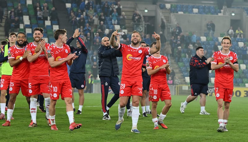 Shelbourne captain Paddy Barrett (centre) leads his teammates over to the visiting fans after Shelbourne beat Linfield 2-0 in Belfast on Thursday to secure a 5-1 aggregate victory in the Uefa Conference League. Photograph: Charles McQuillan/Getty Images