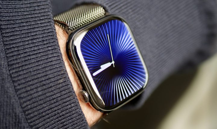 A person wearing the Apple Watch Series 10 in titanium with the Reflections watch face.
