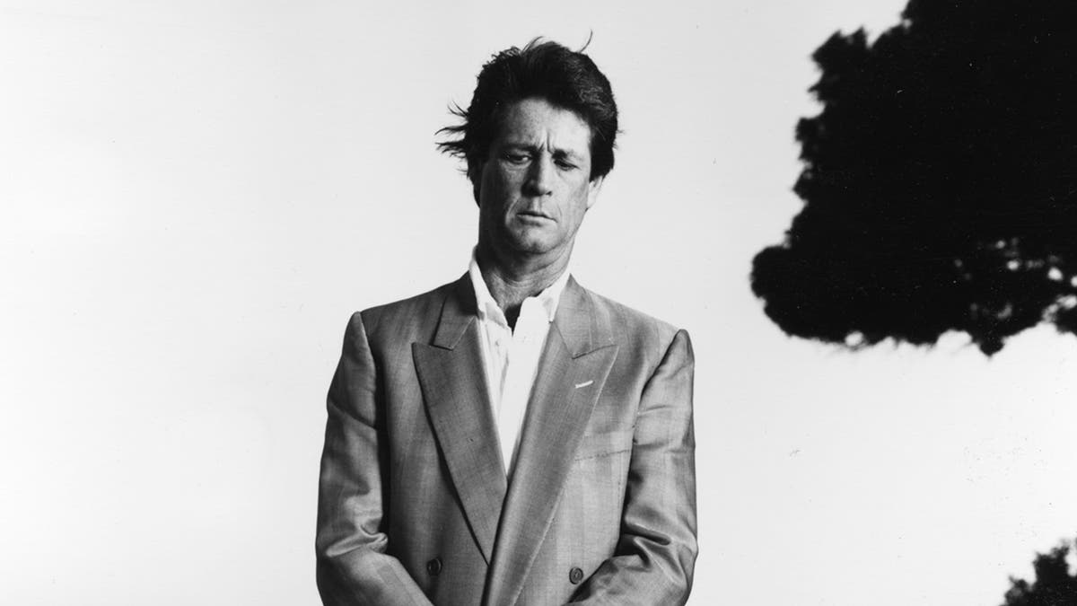 Brian Wilson in a suit with his eyes closed.