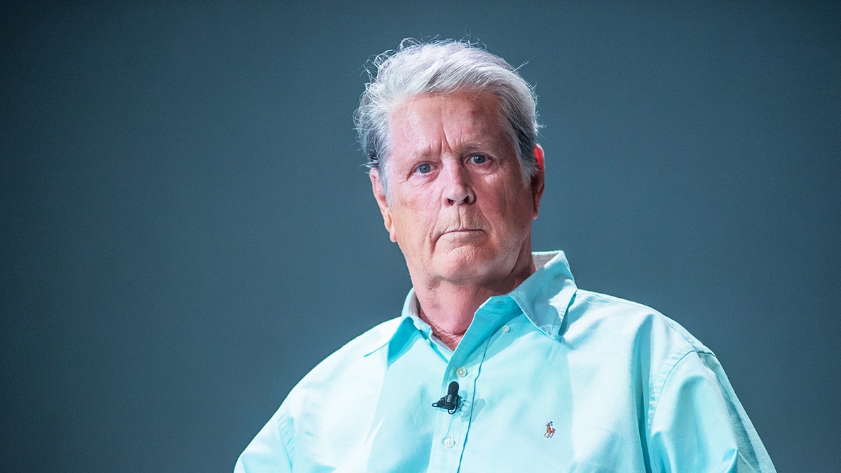 A close-up of Brian Wilson wearing a bright blue shirt.