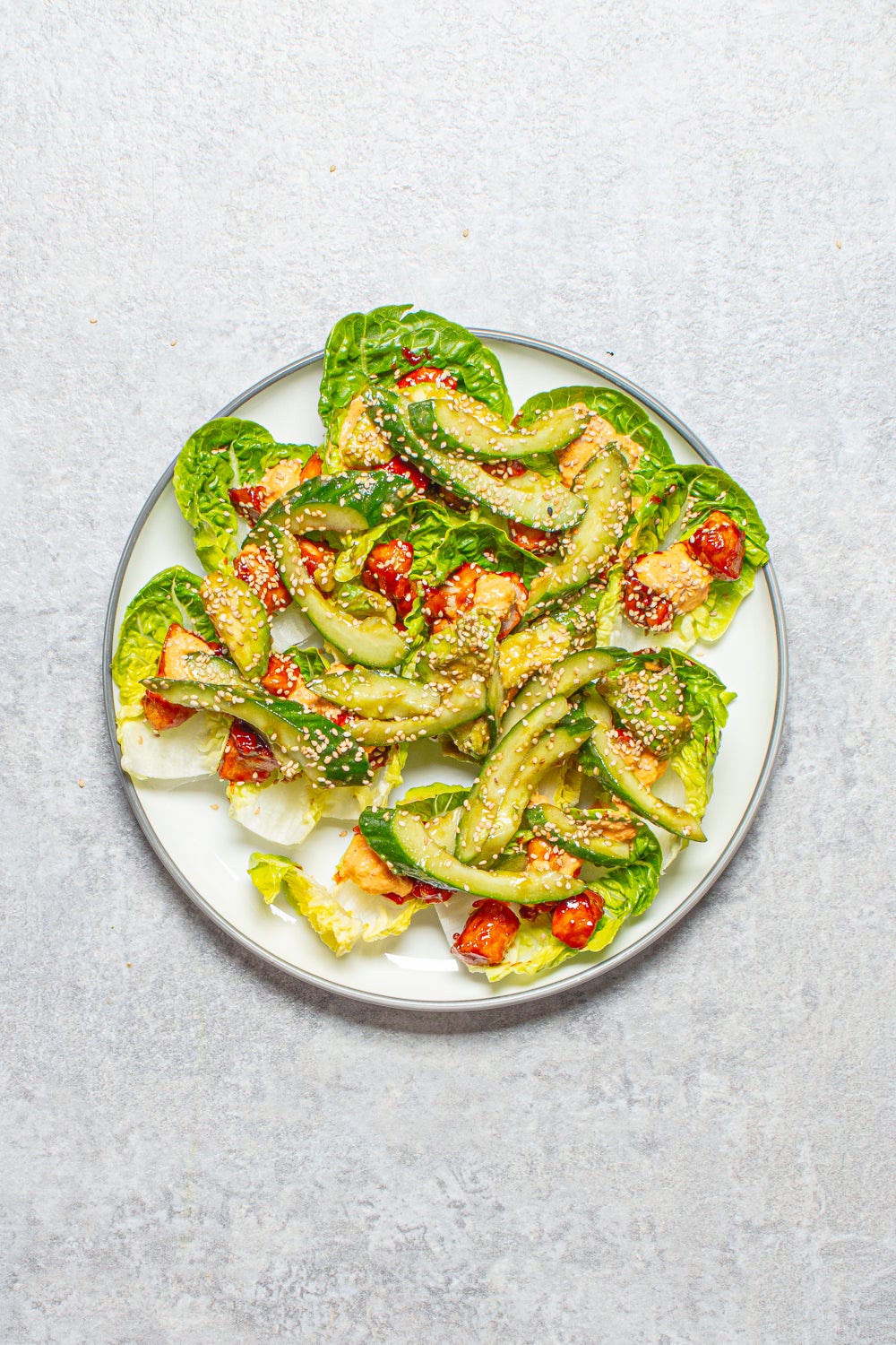 Crisp lettuce cradles sticky Korean-style chicken, cooling salad and a tangy kimchi mayo drizzle