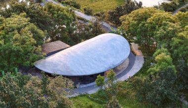 archermit sculpts 'stone kiln in the valley' with petal shaped roof