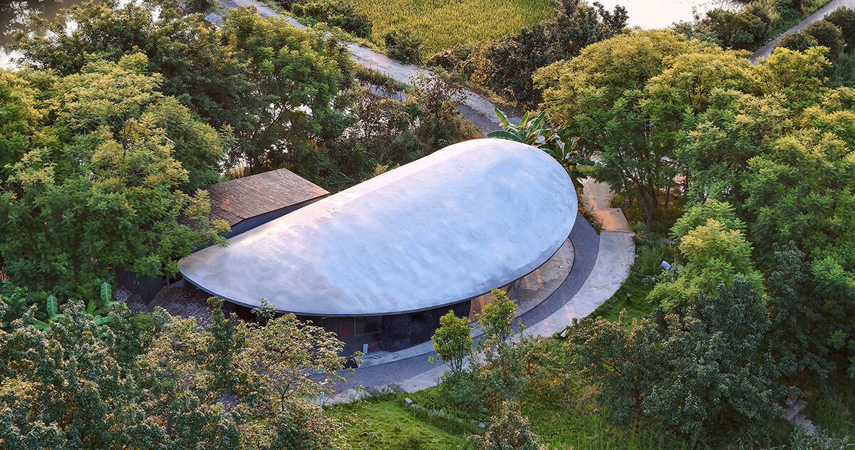archermit sculpts 'stone kiln in the valley' with petal shaped roof