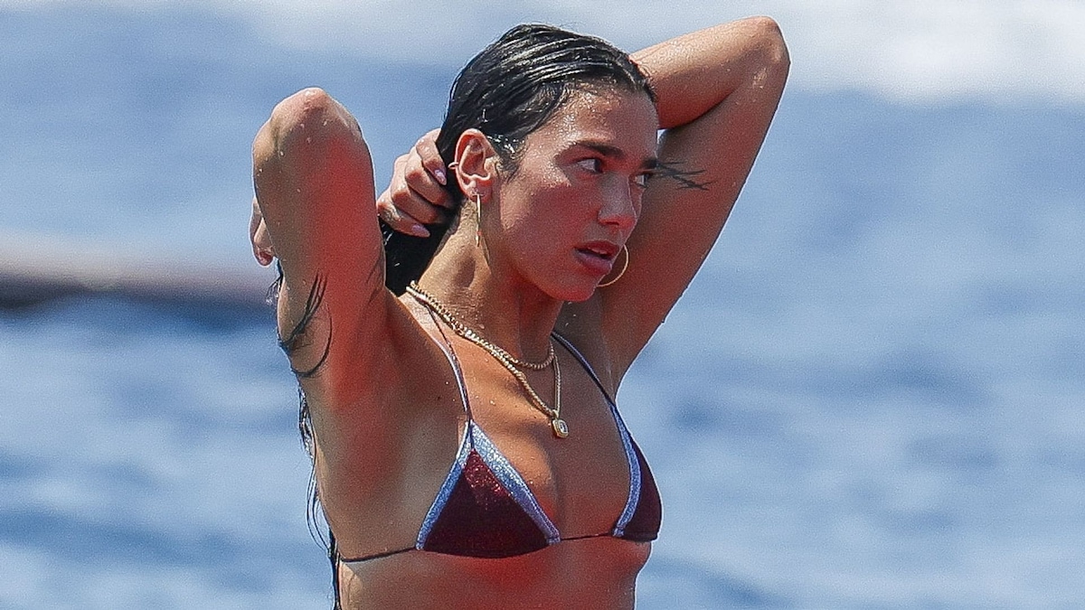 Dua Lipa does yoga on a surfboard in a bikini while celebrating her birthday in Ibiza