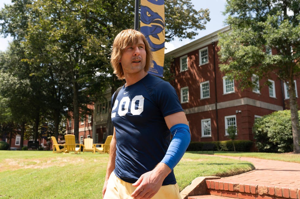 Glen Powell, Chad Powers glen powell as chad powers, a man wears athletic clothing outdoors on a college campus