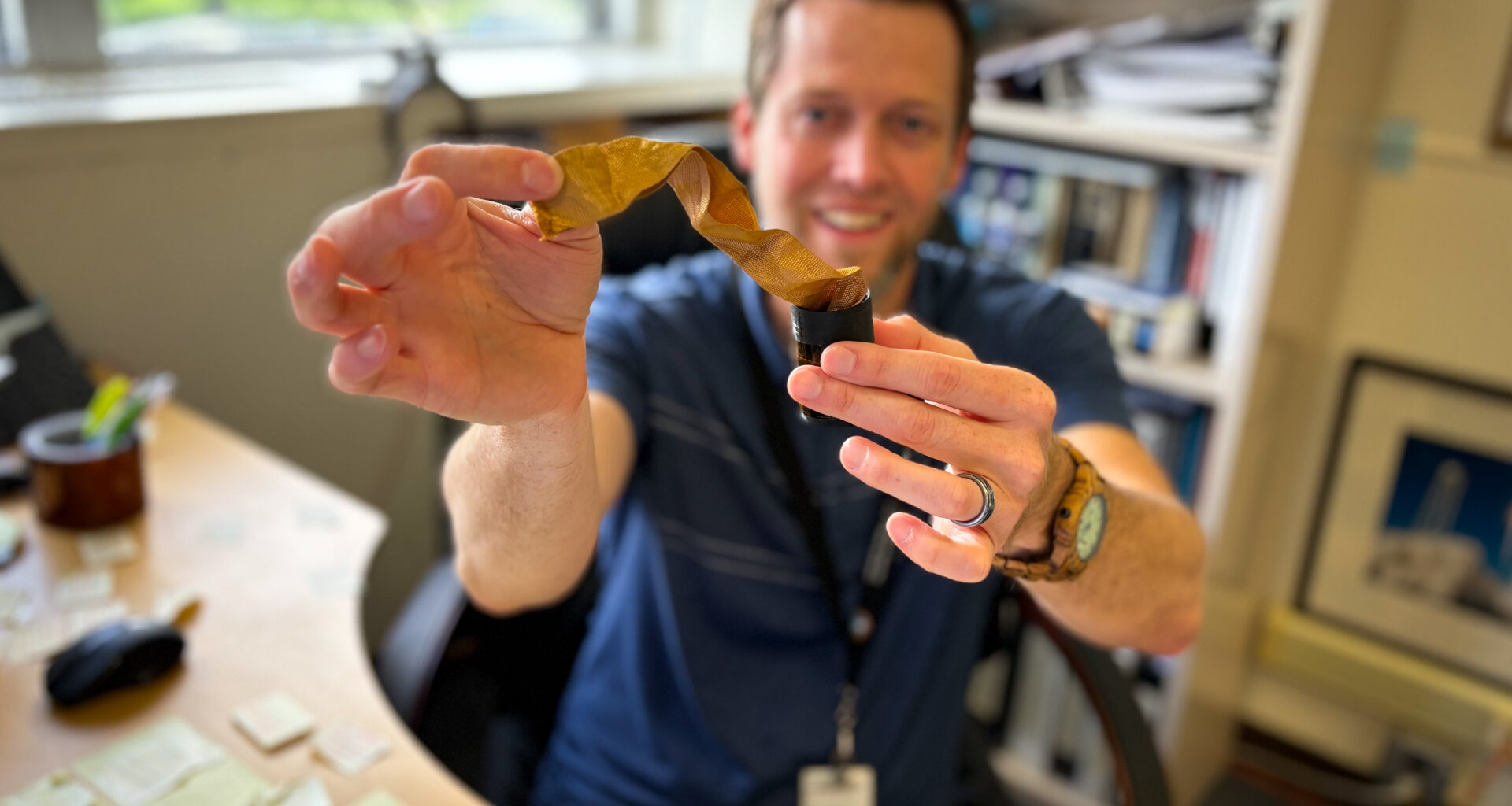 Robert Mosher, HIAD materials and processing lead at NASA Langley, holds up a piece of f webbing material, known as Zylon, which comprise the straps of the HIAD.