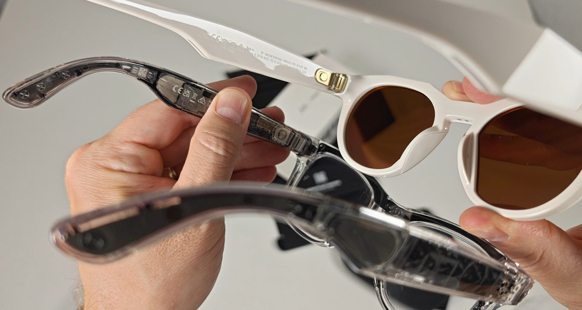 Comparing a transparent pair of Ray-Ban Meta Smart Glasses with Oakley Meta Smart Glasses