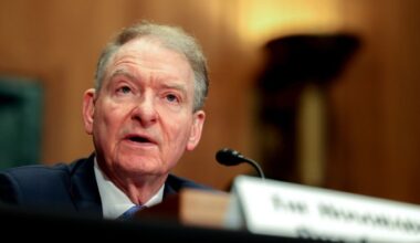 Paul Atkins speaks into a microphone during a Senate committee hearing.