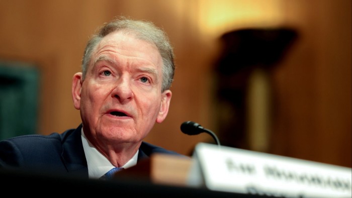 Paul Atkins speaks into a microphone during a Senate committee hearing.