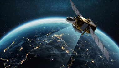 Communication and Telecommunications from Space. Broadcasting, Concept. Communication satellite flies near the night planet earth with night lights of megacities in space with stars. Europe