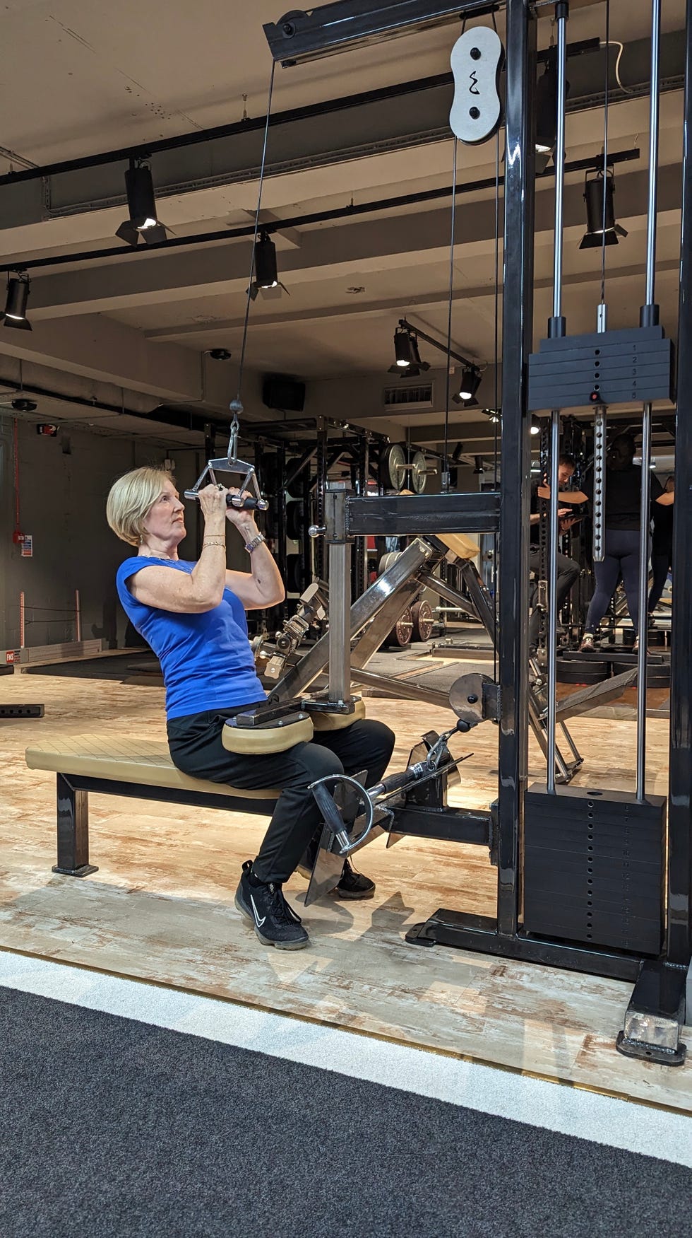 woman using weights machine at gym woman using weights machine at gym