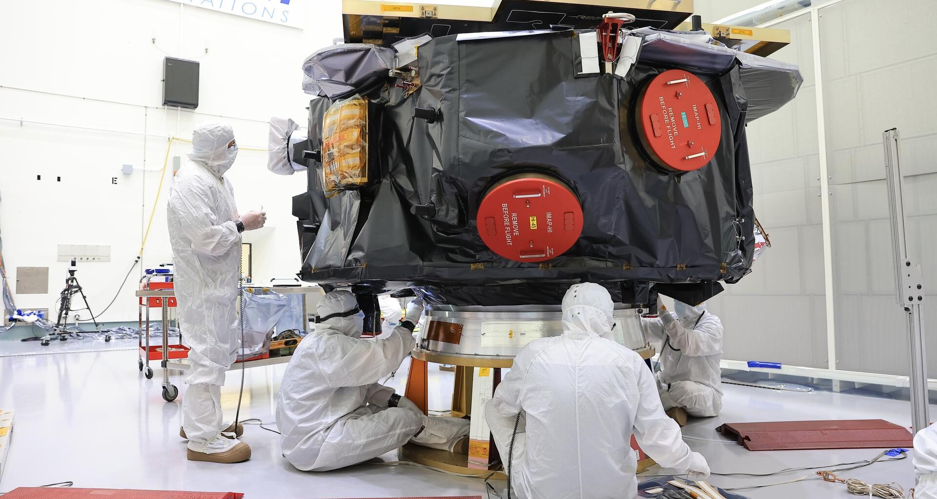 Technicians conduct blanket closeout work on NASA’s IMAP (Interstellar Mapping and Acceleration Probe) observatory at the Astrotech Space Operations Facility near NASA’s Kennedy Space Center in Florida on Friday, Aug. 15, 2025. The IMAP mission will explore and map the boundaries of the heliosphere — a huge bubble created by the Sun’s wind that encapsulates our entire solar system — and study how the heliosphere interacts with the local galactic neighborhood beyond.