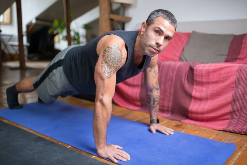 Man doing plank on a yoga mat