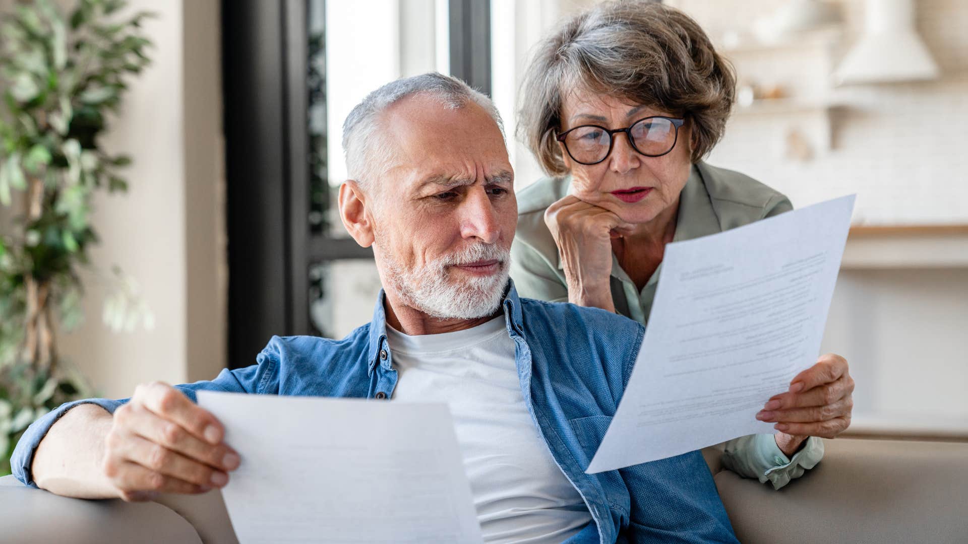 couple carrying over credit card balances doing their bills