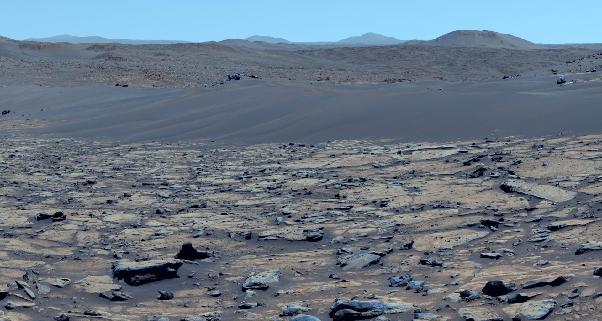 a color-enhanced photo of a Martian landscape that makes the red planet look more Earth-like