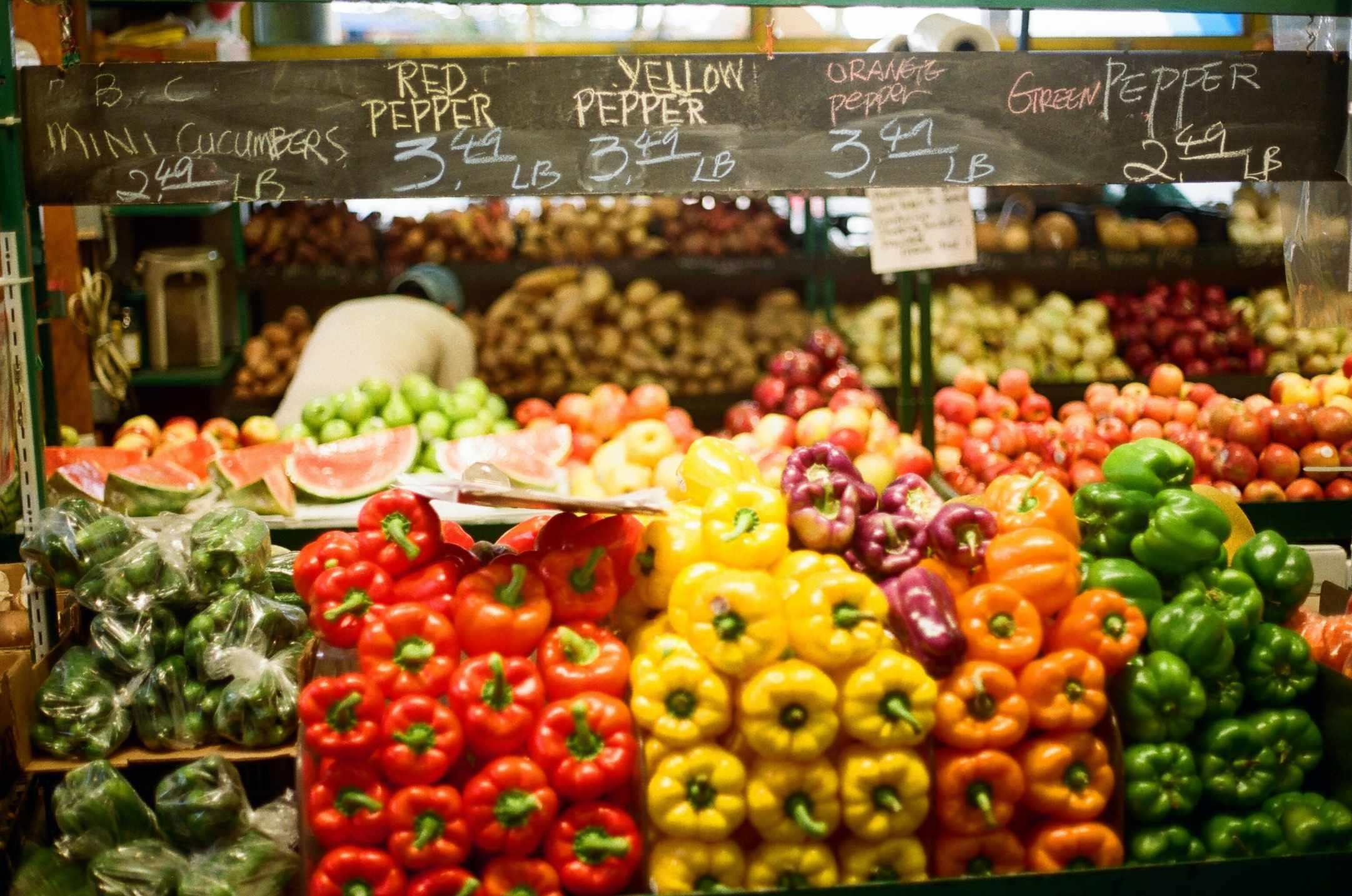 A variety of colorful bell peppers are pictured in a grocery store.
