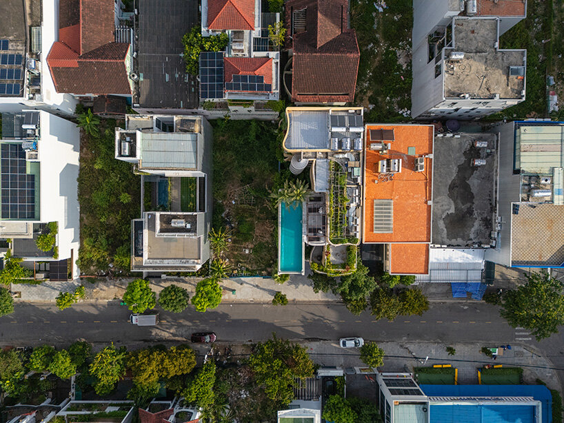 rooftop pool cantilevers from the facade of ho khue architects' hotel in vietnam