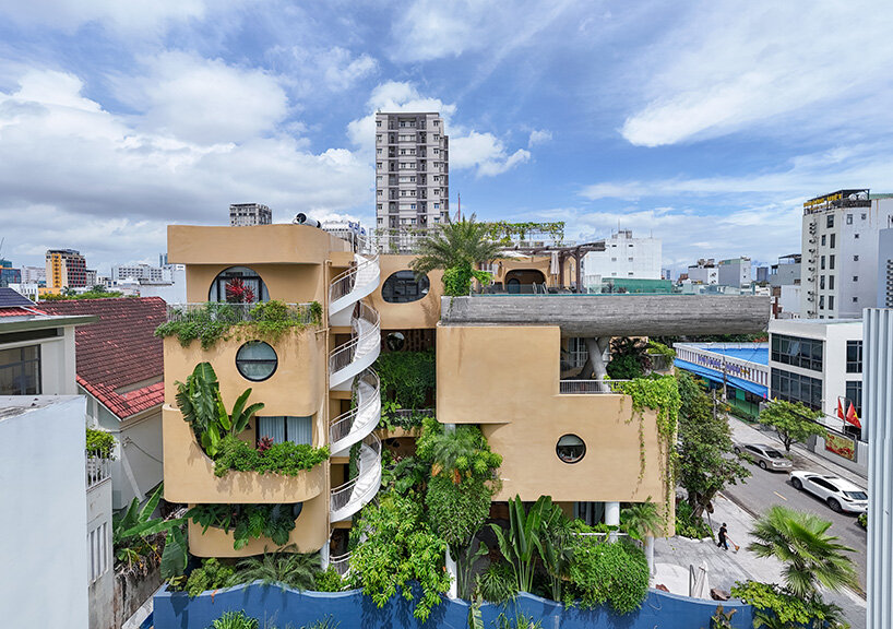 rooftop pool cantilevers from the facade of ho khue architects' hotel in vietnam