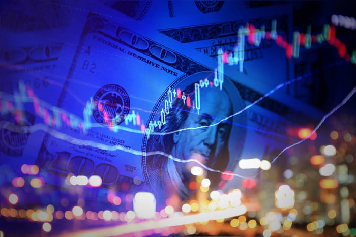 A stock chart with a city skyline and dollar bills in the background.