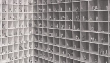 an elaborate ink drawing by Ben Tolman of figures in an abstract building complex, milling around doing different activities in their individual boxes