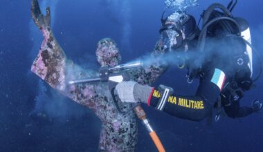 Italian divers wash the popular underwater statue of Christ off Portofino