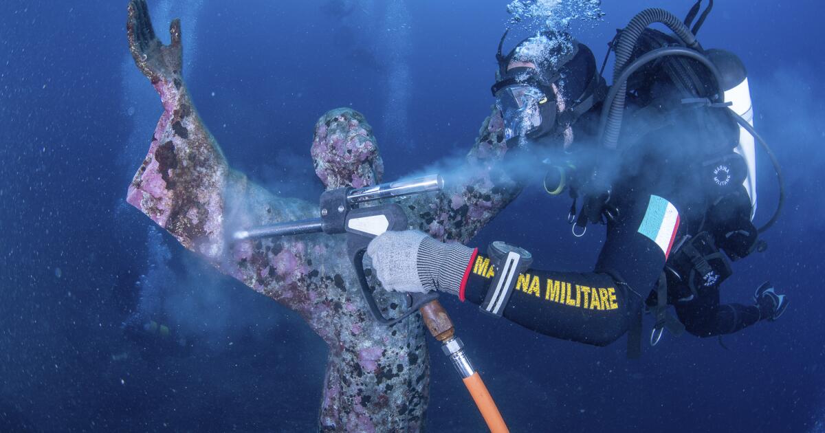 Italian divers wash the popular underwater statue of Christ off Portofino