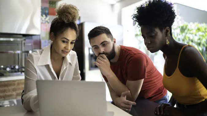 Real estate agent/financial advisor talking to a young couple stock photo