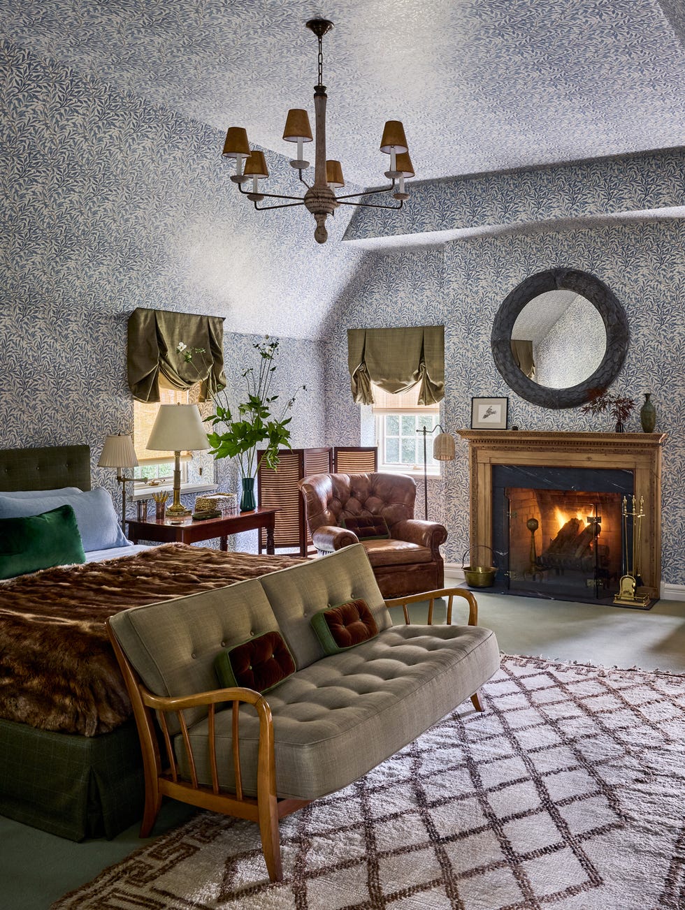 Cozy bedroom with vintage decor, featuring a fireplace and seating area. Cozy bedroom with vintage decor, featuring a fireplace and seating area.