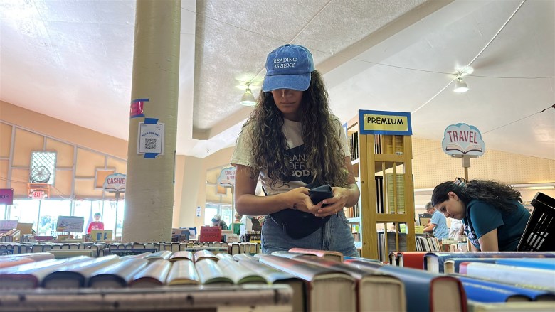 Book sale shoppers look through the thousands of available titles.