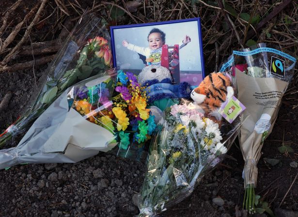 Floral tributes and a photograph of Daniel Aruebose
