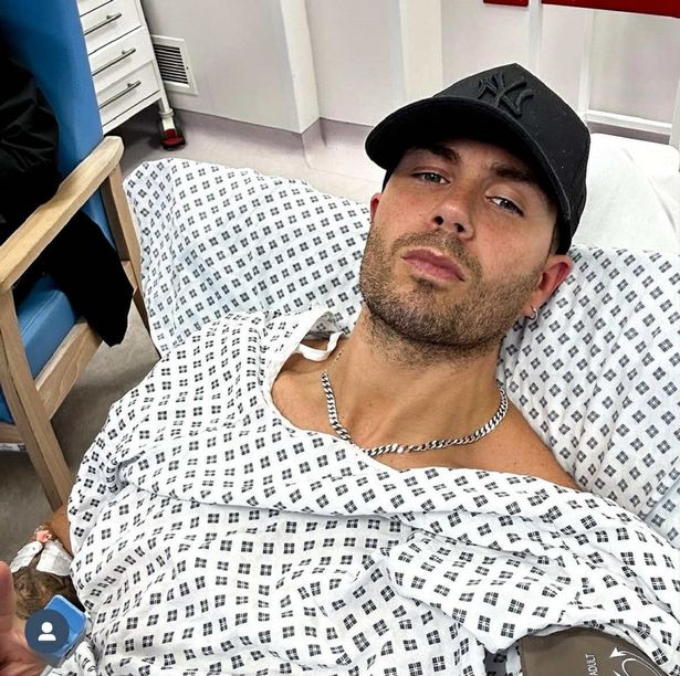Max George in a hospital gown