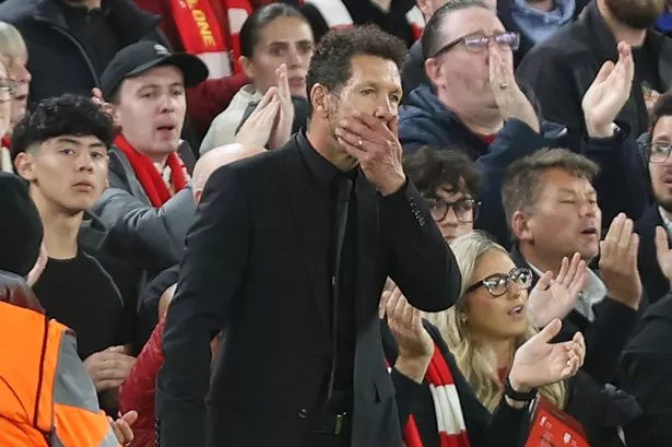 Diego Simeone with his right hand over his mouth