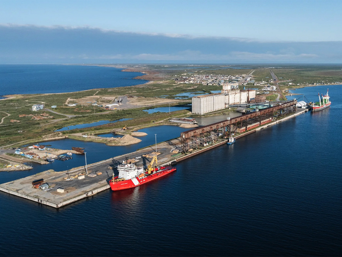 An aerial view of a red and white Canadian Coast Guard vessel dockside at the Port of Churchill.