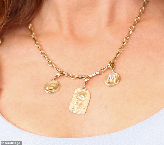 She wore an S&M themed necklace featured the letters and a pendant with an image of a body