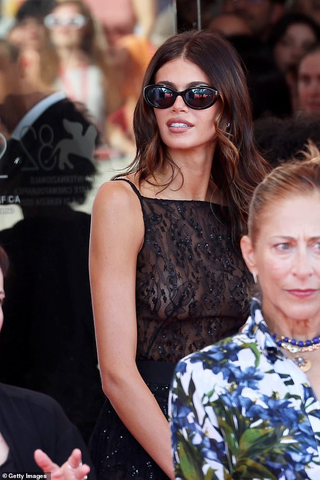 The fashion favourite put on a daring display in the sheer lace dress which was adorned with matching sequins