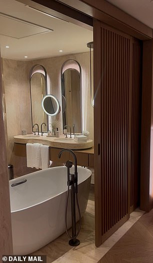 The luxurious bedroom features a huge bed and bathroom as well as a walk-in wardrobe and lowered seating area with a view overlooking the ocean