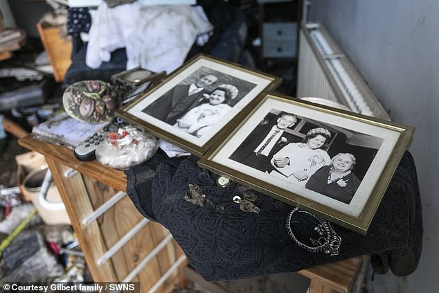 Family photos of Maureen Gilbert and her husband Jack Gilbert seen in her home after the flood