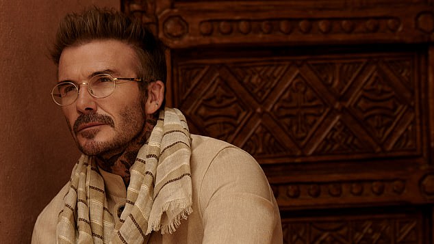 He upped the style stakes in another shot with a scarf and shirt paired with gold framed glasses with a thin frame